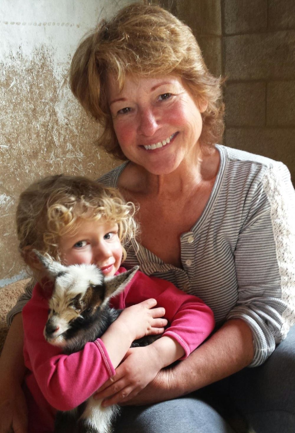 Diane and her Granddaughter with a Baby Goat